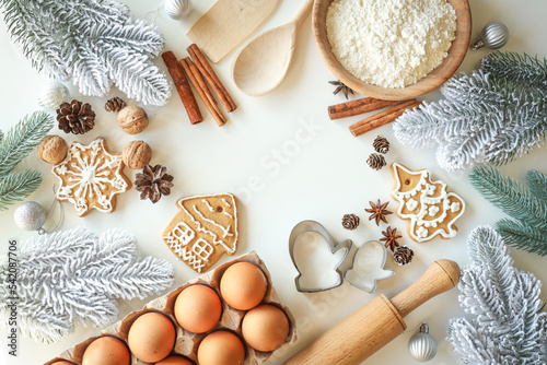 Bakery background with ingredients for cooking Christmas baking. Flour, eggs, cinnamon and gingerbread on the table top view