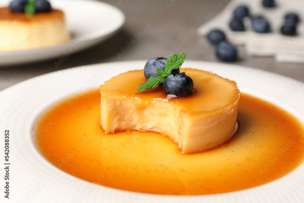 Delicious pudding with caramel and blueberries on plate, closeup Delicious pudding with caramel and blueberries on plate, closeup