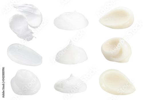 Set with smears of body creams on white background