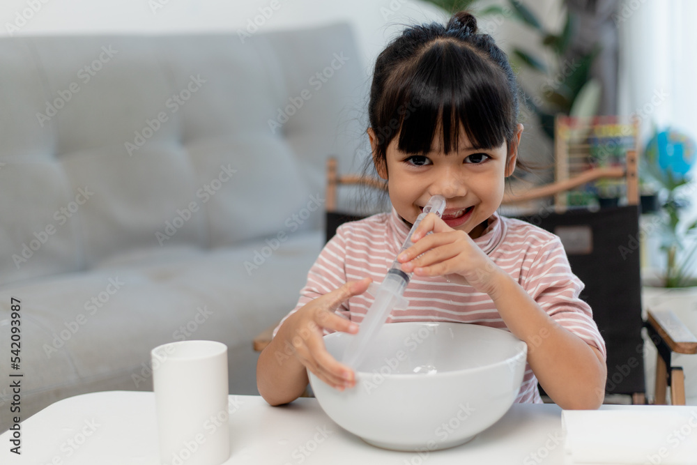 Little asian girl saline nasal wash nose at home. Little asian girl saline nasal wash nose at home.