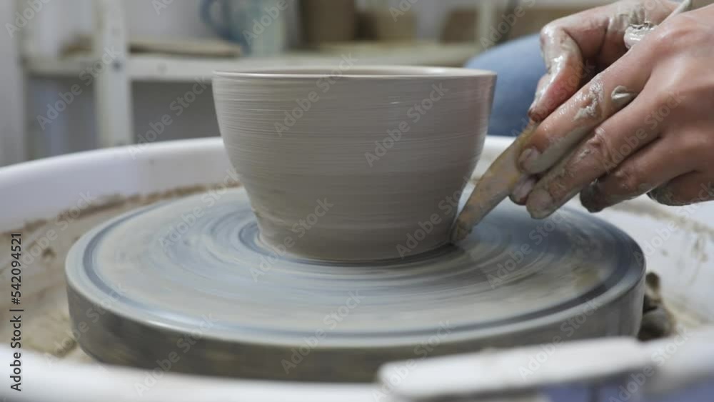 Young woman artist in the pottery studio making bowl with her hands, handmade creative artist. Young woman artist in the pottery studio making bowl with her hands, handmade creative artist.