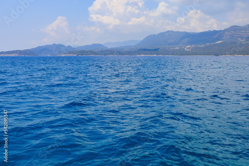 View of the rocky shore from the sea. Mediterranean Sea in Turkey. Popular tourist places. Background