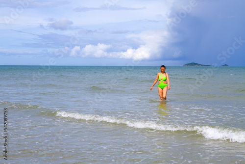 Woman with swimsuit happy in the rain at beach © suthin3