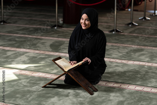 Young Beautiful Muslim Woman Praying With Quran