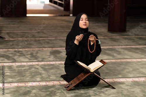 Humble Muslim Woman is Praying in the Mosque