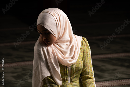 Young Muslim Woman is Praying in the Mosque