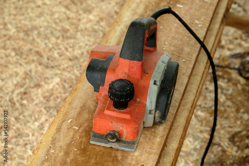 Electric jack planer with wires at work on board