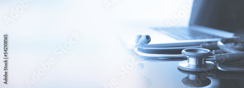 healthcare and medicine background. Medical stethoscope and laptop computer on table with copy space. Online medical, e-health education, Health business web banner