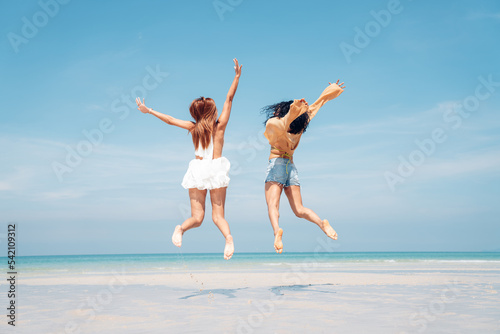 Happy girl jumping on the beach, Beach summer holiday sea people concept