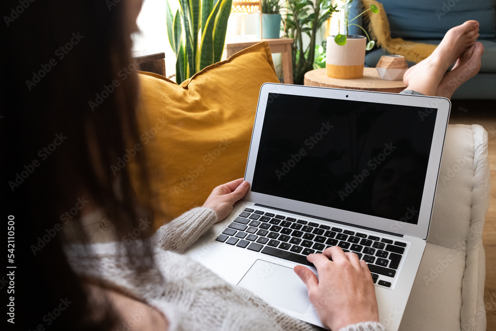 POV of young caucasian woman using laptop relaxing at home lying on couch. POV of young caucasian woman using laptop relaxing at home lying on couch.