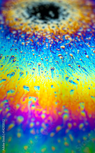 Photogtaphy of Iridescent multicolored bright abstract soapy water. Space  halographic  psychedelic background for screensaver.