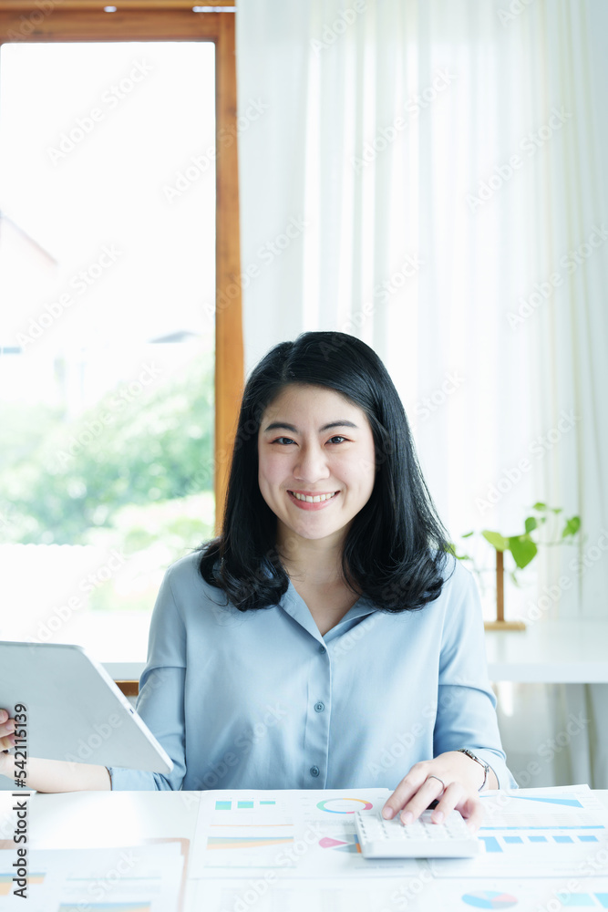 financial, Planning, Marketing and Accounting, portrait of Asian employee checking financial statements using documents and calculators at work financial, Planning, Marketing and Accounting, portrait of Asian employee checking financial statements using documents and calculators at work
