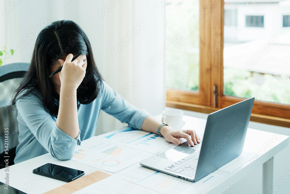 Portrait of sme business owner, woman using computer and financial statements Anxious expression on expanding the market to increase the ability to invest in business