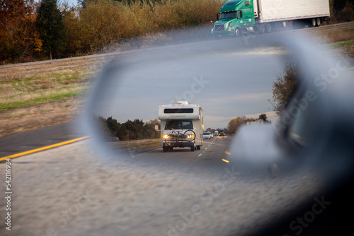 RV through side view mirror on road