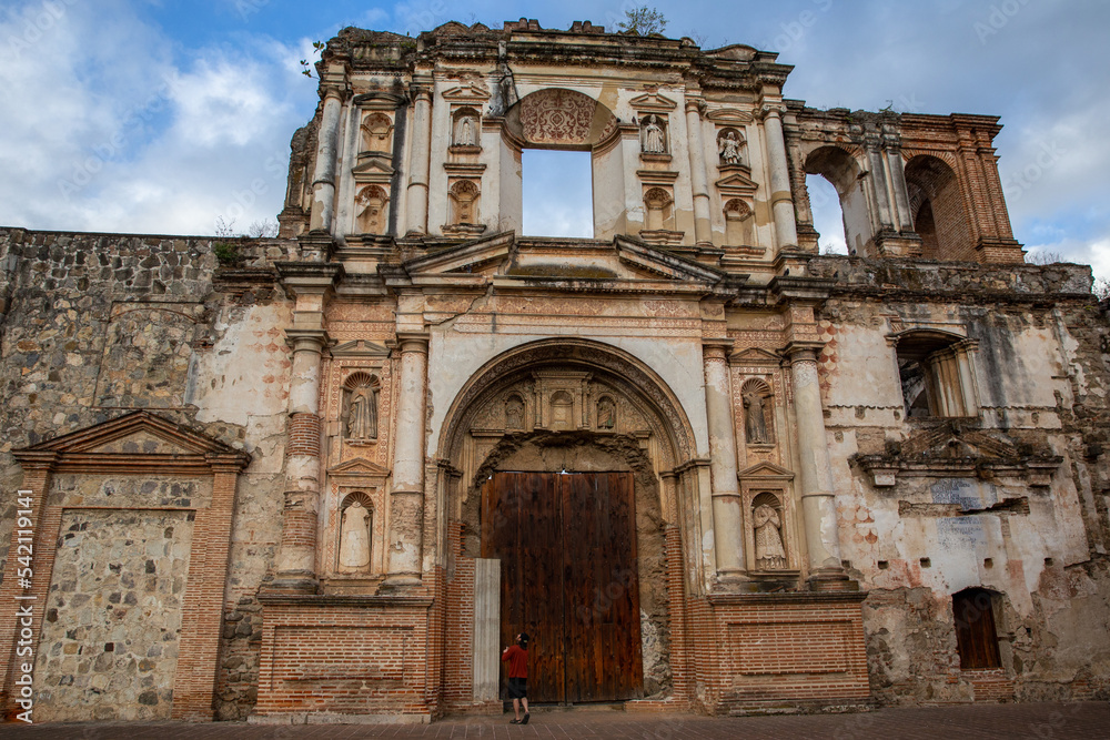 Man admires Temple and College of the Company of Jesus in Guatemala