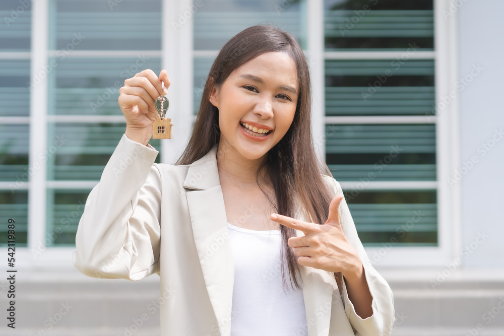 New home owner, happy family asian young woman smile holding, cheerful girl showing apartment house key. Banker agreement mortgage loan purchase buy, property lease real estate for relocation