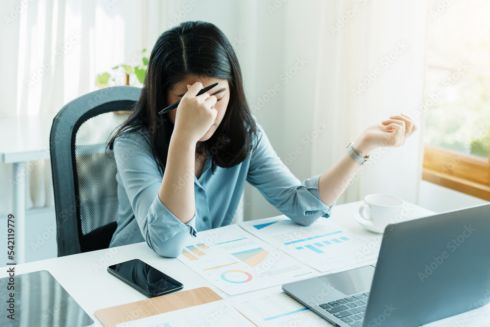 Portrait of sme business owner, woman using computer and financial statements Anxious expression on expanding the market to increase the ability to invest in business Portrait of sme business owner, woman using computer and financial statements Anxious expression on expanding the market to increase the ability to invest in business