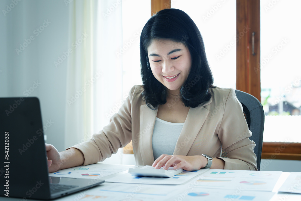 Accountants, Asian auditors are using calculators and computers to review annual tax budgets to submit information to the IRS. Accountants, Asian auditors are using calculators and computers to review annual tax budgets to submit information to the IRS.