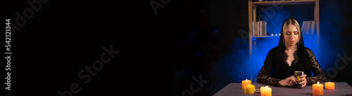 Tarot reader picking tarot cards.Candlelight in dark.Tarot reader or fortune teller reading and forecasting concept.