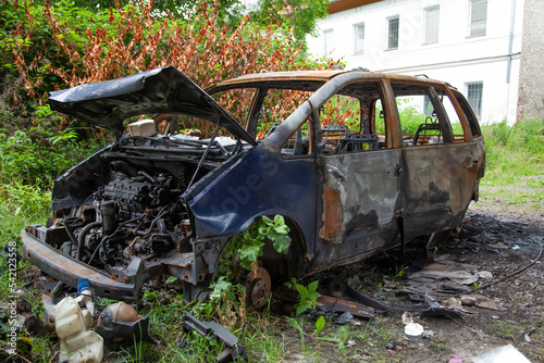 Car after a fire. Burnt rusty car after fire or accident. Car after the fire  crime of vandalism  riots. Arson car. Accident on the road due to speeding. Explosion.