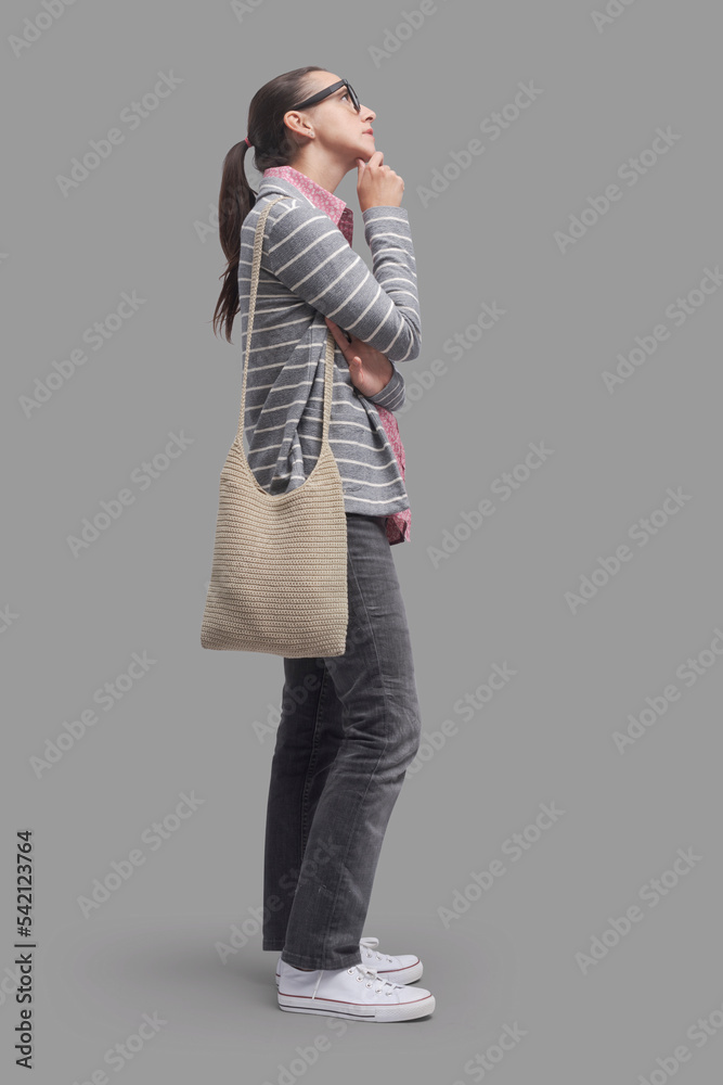 Pensive woman standing and looking away Pensive woman standing and looking away