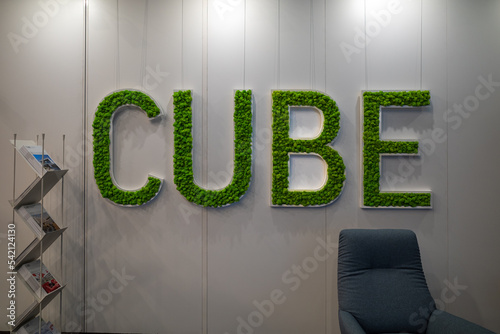 on one wall is written the word Cube with letters made of moss