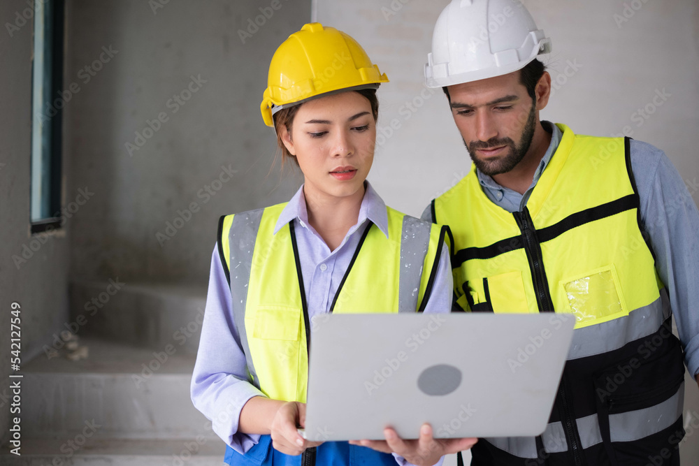 Engineers on building site. Engineer are working contruction on site plans to build high-rise buildings building. Architect caucasian man working with colleagues mixed race in the construction site. Engineers on building site. Engineer are working contruction on site plans to build high-rise buildings building. Architect caucasian man working with colleagues mixed race in the construction site.