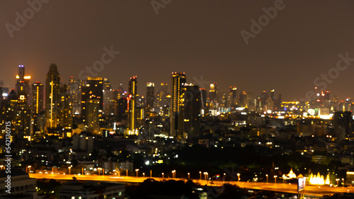 Blurred of bokeh city aerial view from the rooftop view point image in the night © SASITHORN