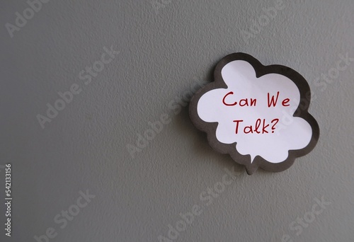 Word balloon note on gray wall written CAN WE TALK? -concept of boss , manager, partners or friends approach to have a serious talk or difficult conversation to solve conflicts or relationship issues