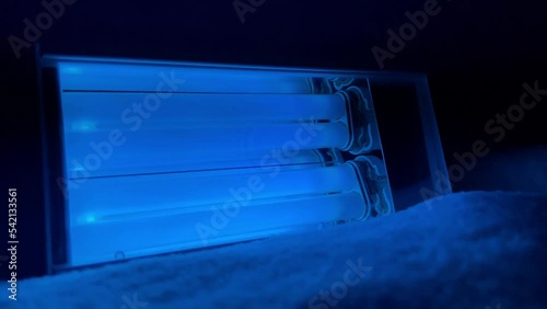 Handheld UVB treatment lamp turning on for patients of vitiligo, psoriasis, or eczema.