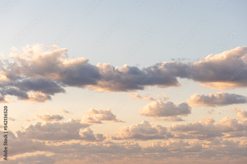 Background of sky with tender cumulus golden clouds. Heaven with cloudscape with copy space. Concept of freedom and weather