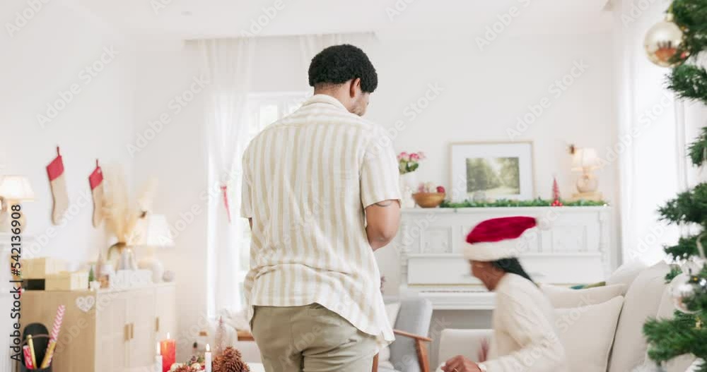 Couple, christmas and gift with love, surprised and wow with holiday celebration in festive season in home. Black man giving present to woman with happiness, celebrate and christmas tree decoration Couple, christmas and gift with love, surprised and wow with holiday celebration in festive season in home. Black man giving present to woman with happiness, celebrate and christmas tree decoration
