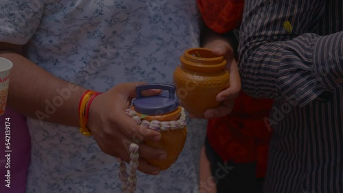 A man with his hands to offer ganga water in the kashi vishwanath temple in varanasi photo