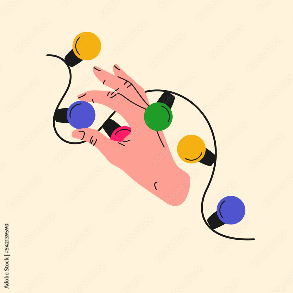 A persons hand is holding a light bulb. Christmas garland with colorful light bulbs. A persons hand is holding a light bulb. Christmas garland with colorful light bulbs.