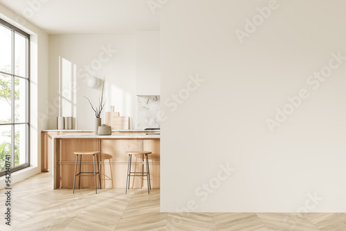 Light kitchen interior with bar countertop and cooking area, window. Empty wall