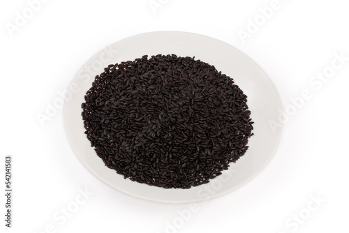 Raw long-grained black rice on a white dish