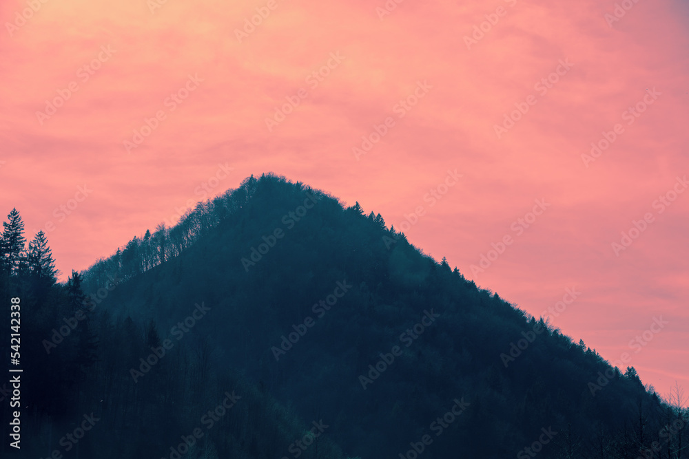 Silhouette of the mountain against a pink sunset sky Silhouette of the mountain against a pink sunset sky