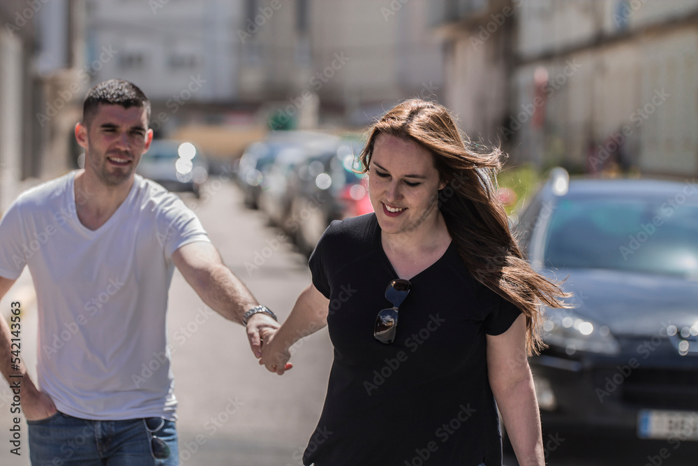 Young couple in love walking holding hands. Photography that represents love