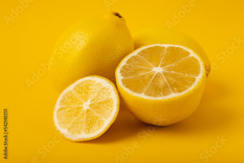 Sliced lemons on a yellow background.