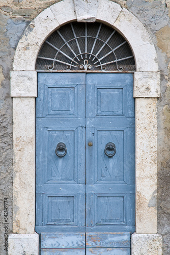 Old blue wooden door. Umbria, Italy