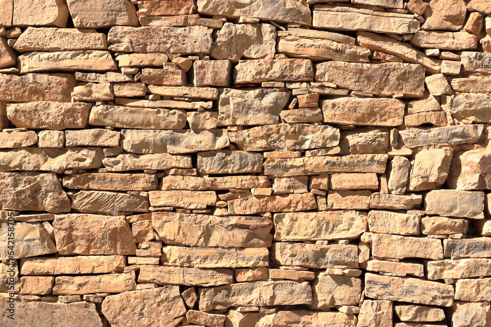 Obraz premium Old medieval yellow wall made from stone