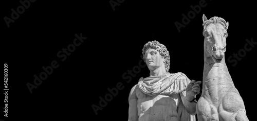 Ancient marble statue of mythical characters Castor and Pollux with horse, dated back to the 1st century BC, located at the top of monumental balustrade in Capitoline Hill, in Rome (Black and White wi