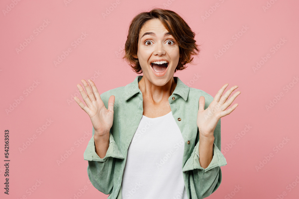 Young overjoyed happy exultant woman wear mint shirt white t-shirt look camera spread hands say wow awesome isolated on plain pastel light pink background studio portrait. People lifestyle concept Young overjoyed happy exultant woman wear mint shirt white t-shirt look camera spread hands say wow awesome isolated on plain pastel light pink background studio portrait. People lifestyle concept