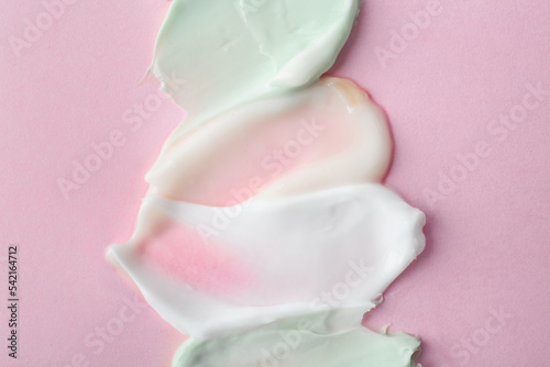 Sample of cream on pink background, top view