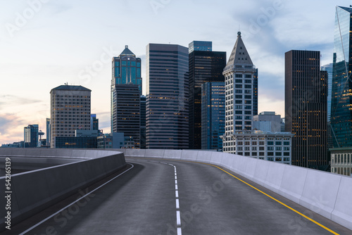 Empty urban asphalt road exterior with city buildings background. New modern highway concrete construction. Concept way to success. Transportation logistic industry fast delivery. Seattle. USA.