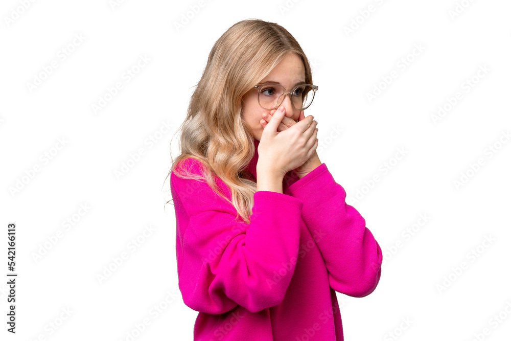 Young English woman over isolated background covering mouth and looking to the side Young English woman over isolated background covering mouth and looking to the side