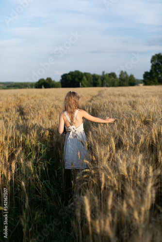 sisters play in dresses, wheat field, family walk, girls on a picnic. © Lilia