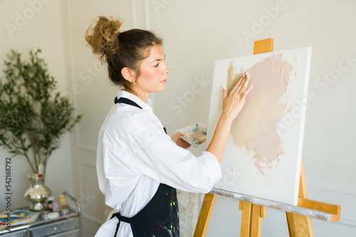 Female artist looking creative while painting