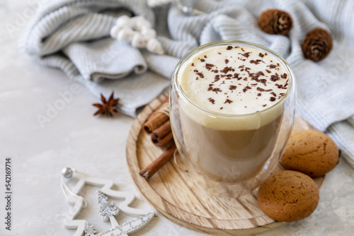 Fototapeta Naklejka Na Ścianę i Meble -  Seasonal winter concept with hot drink. Latte spice coffee, warm pullover and Christmas decor on gray background. Copy space.