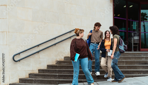 Принти на полотні Young students leaving university after lesson - Youth and education concept